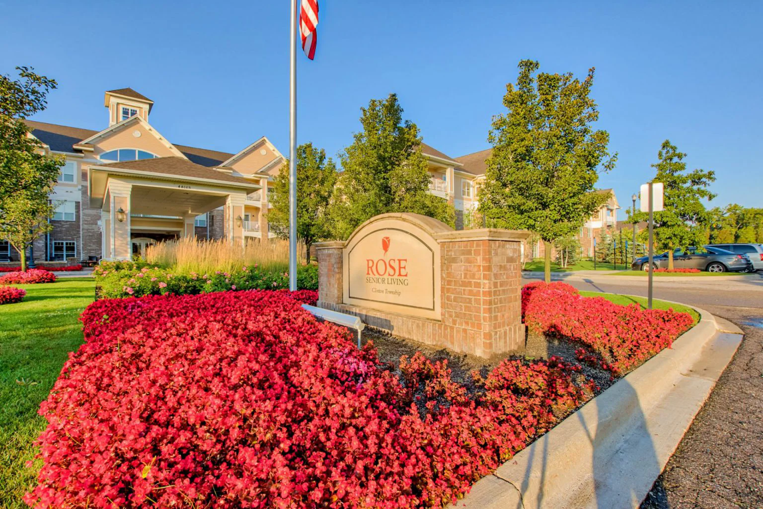 Exterior view of Rose Senior Living with flowers