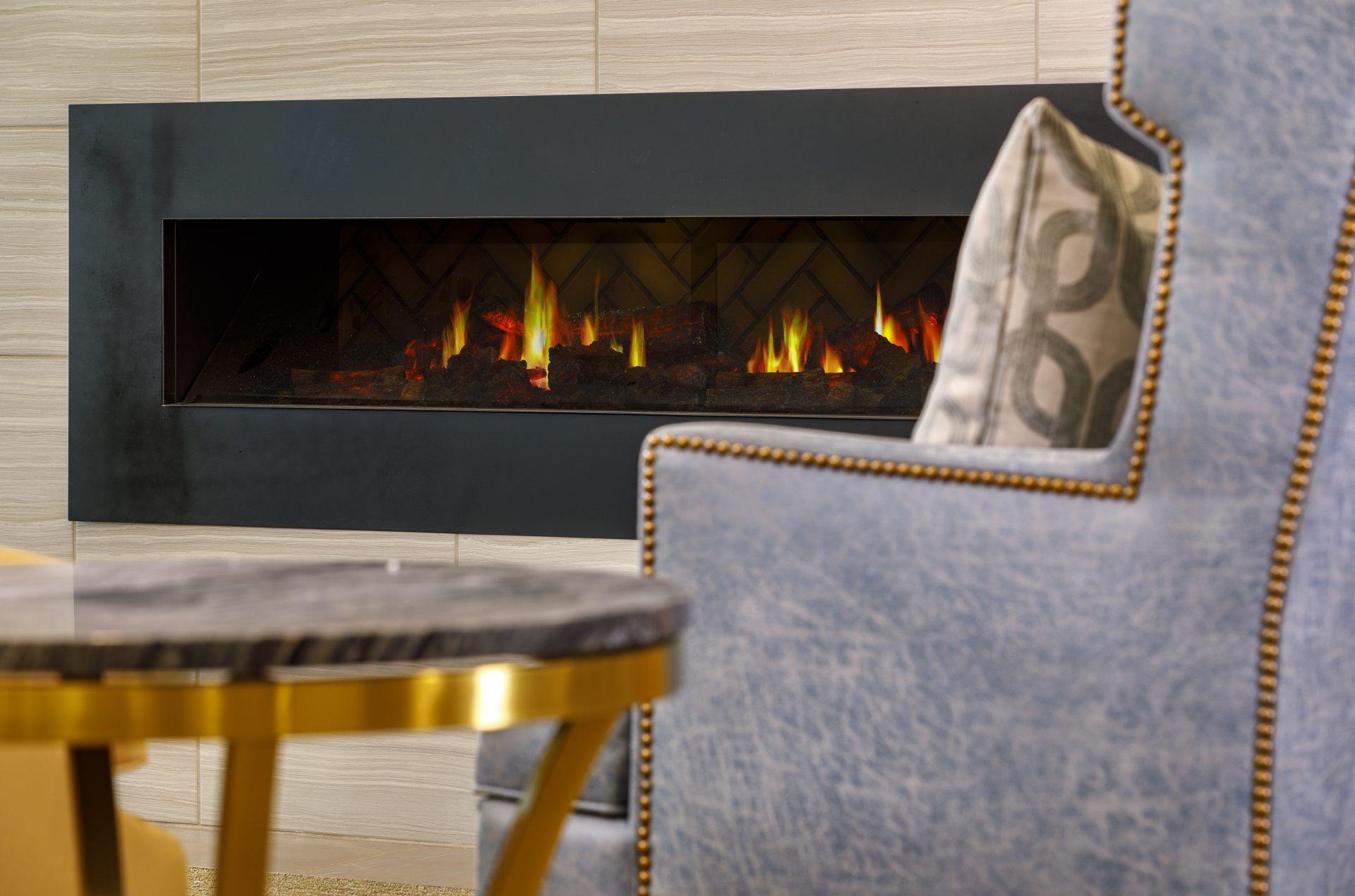 Cozy fireplace in a lounge area with a chair