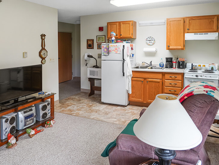 Interior view of a resident's room with kitchen area