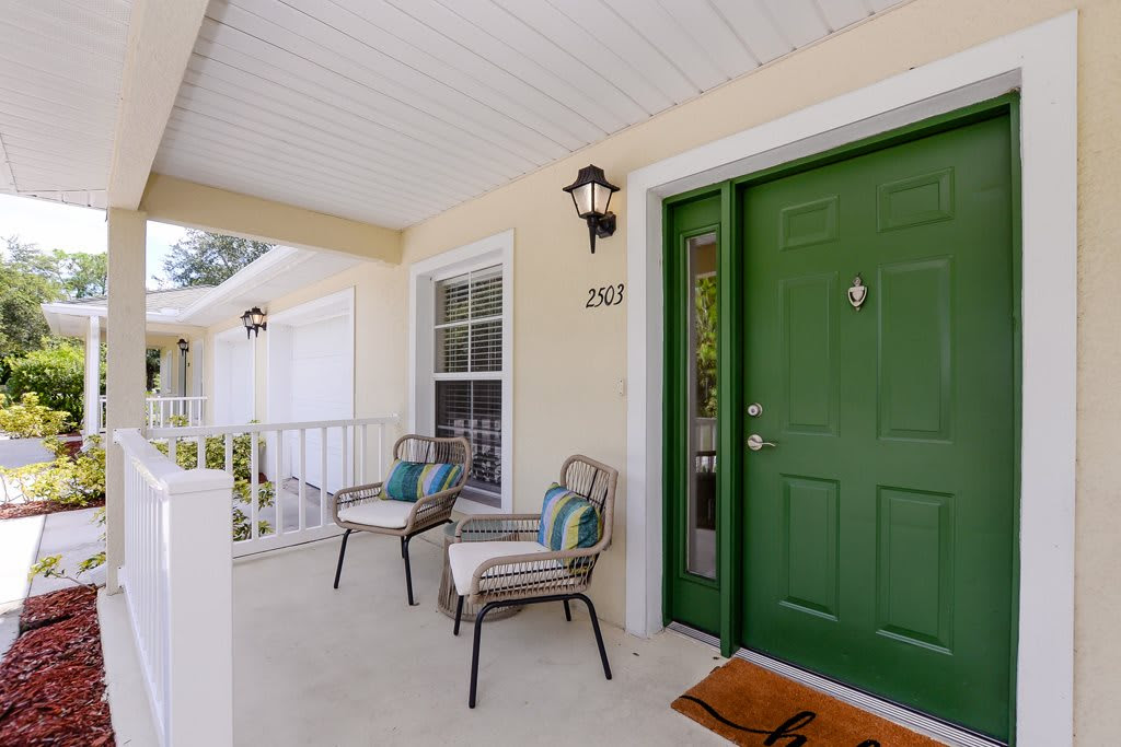 Exterior view of a welcoming entrance with green door