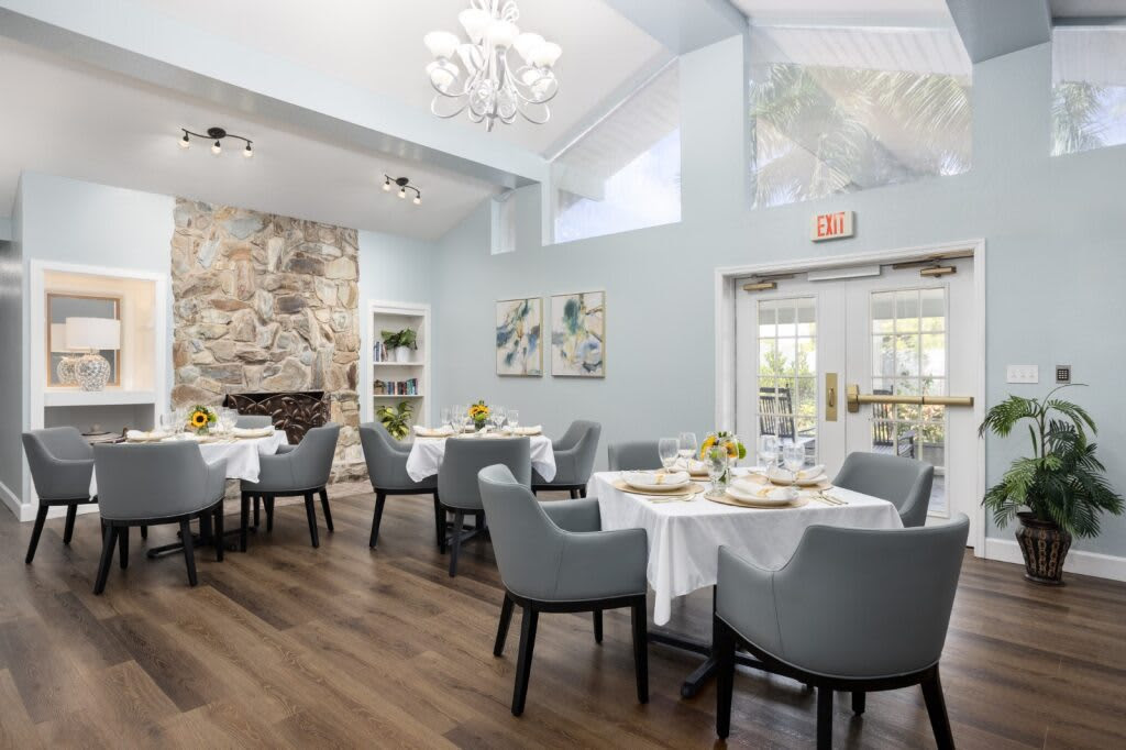 Bright dining room with tables set for meals