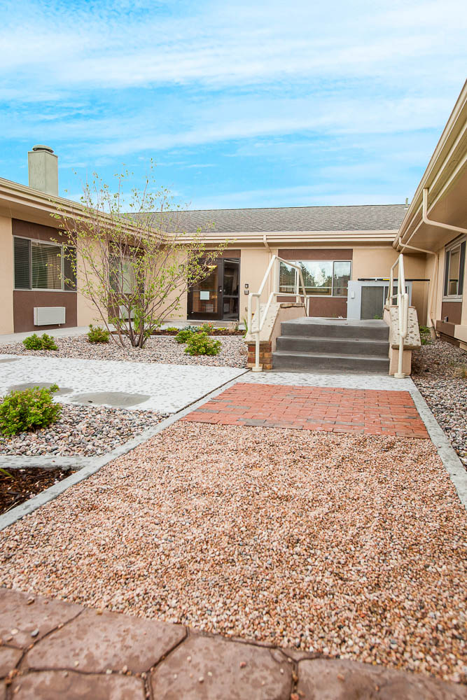Pathway leading to an entrance with landscaping