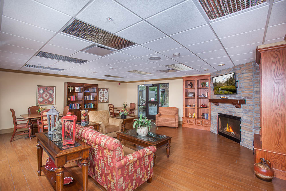 Bright common area with seating and a fireplace