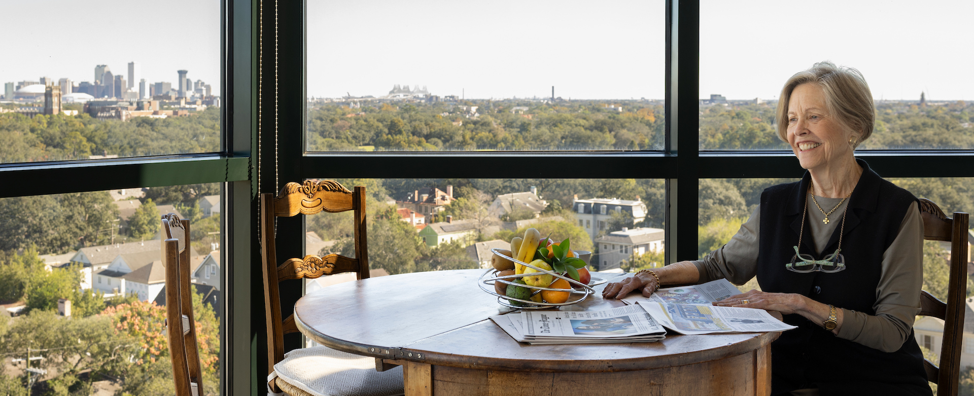 Resident enjoying a view with a newspaper at a table
