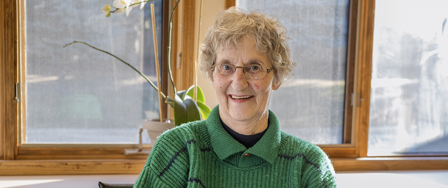 Senior resident smiling in a sunny room