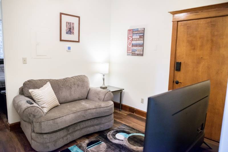 Cozy interior of a resident's room with sofa and lamp