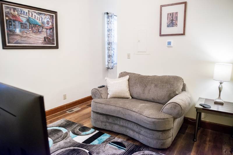 Cozy nook featuring a soft couch and decorative items