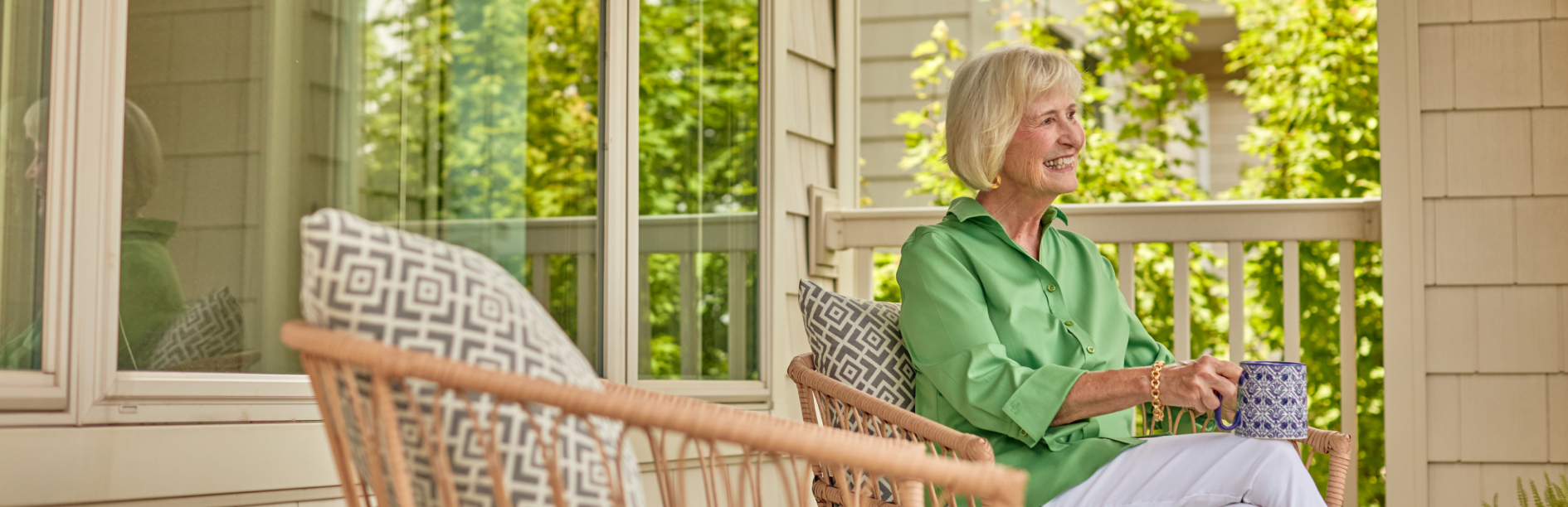 Senior woman enjoying coffee on a balcony