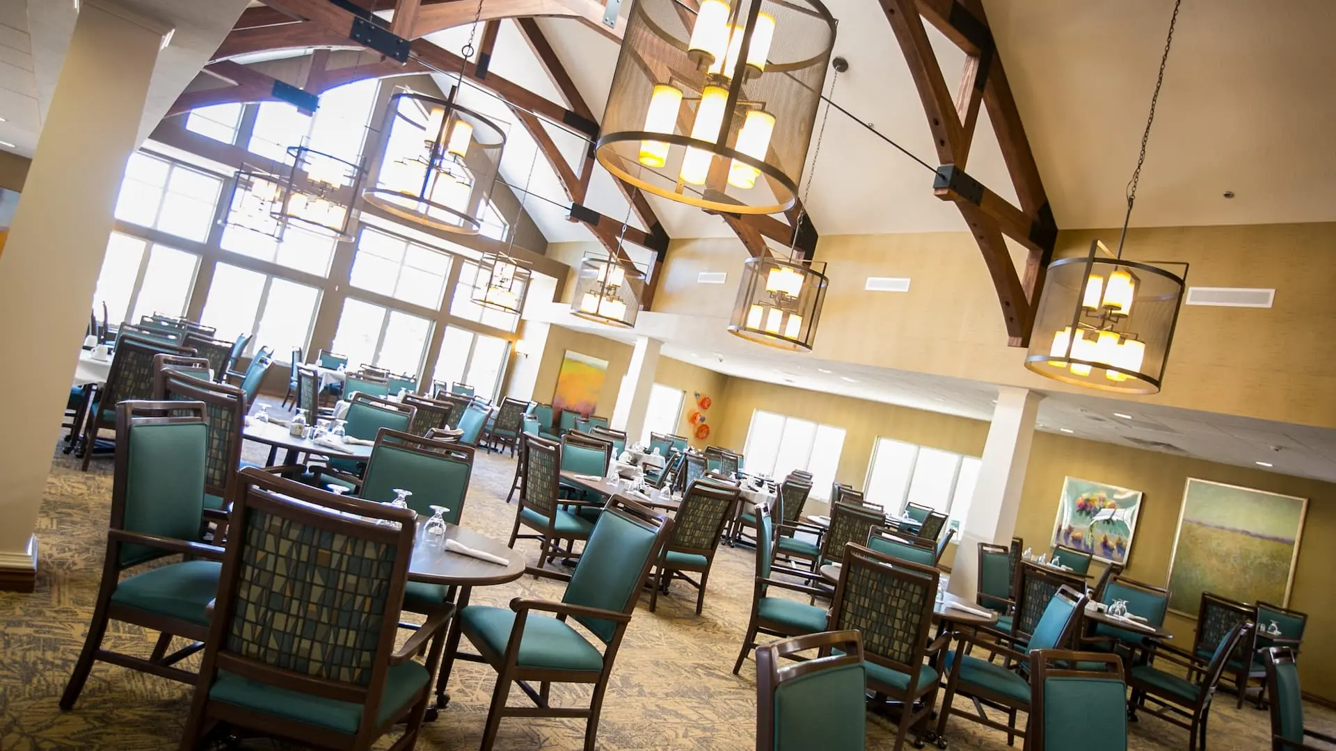 Bright dining area with large windows and wooden beams