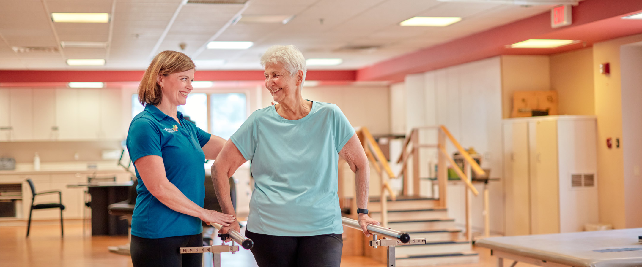 Therapist assisting a resident in a bright activity room