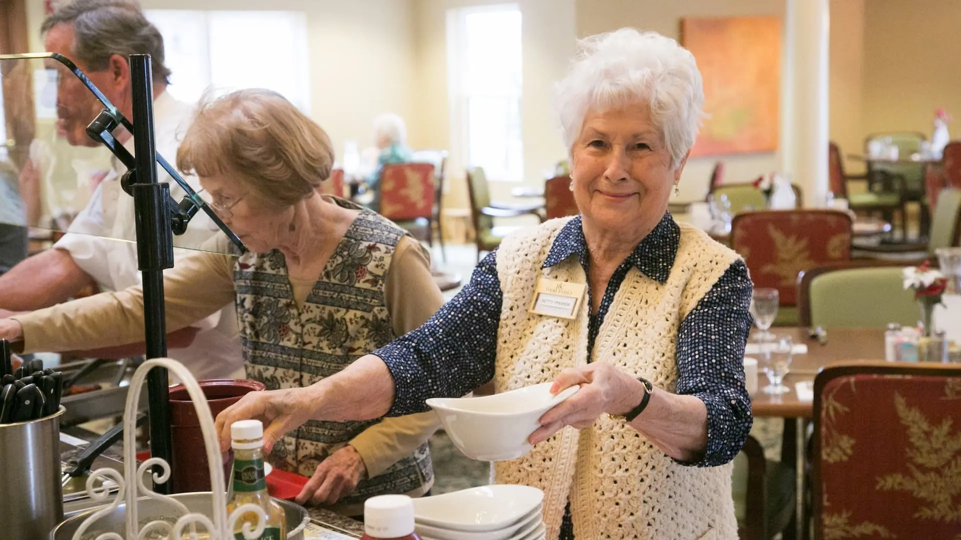 Residents enjoying meal service in the dining room