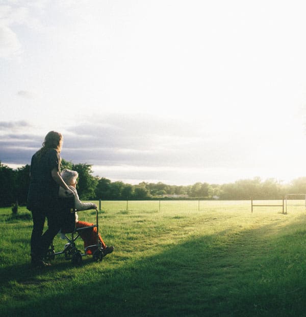 Caregiver assisting a resident in a field