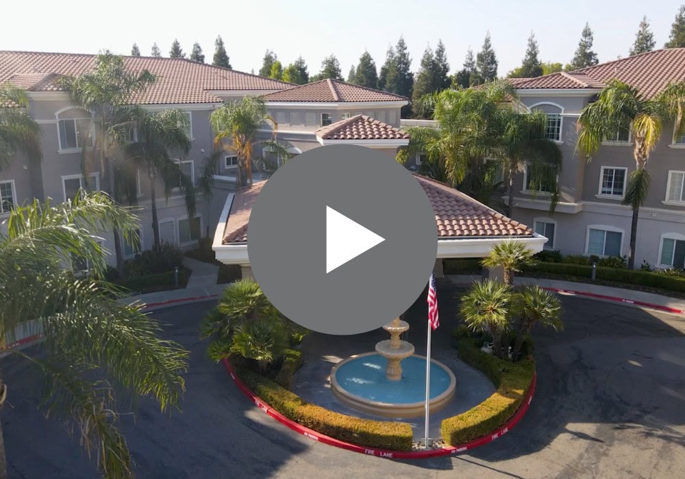 Aerial view of the facility entrance with fountain and palm trees