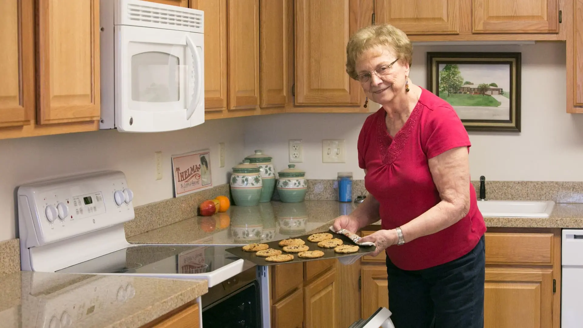 Resident baking cookies in an apartment kitchen