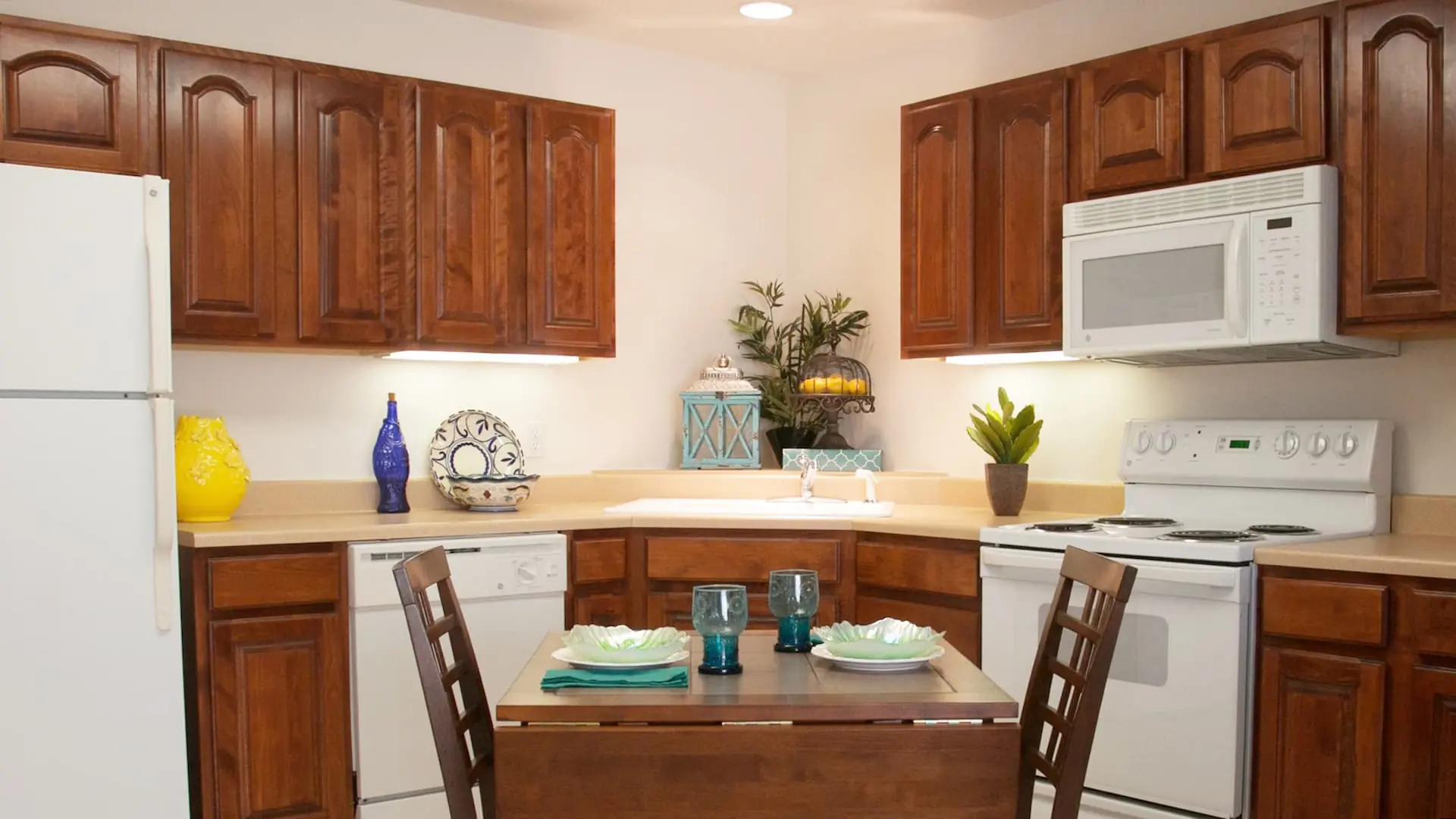 Cozy kitchen area with wooden cabinets and dining table