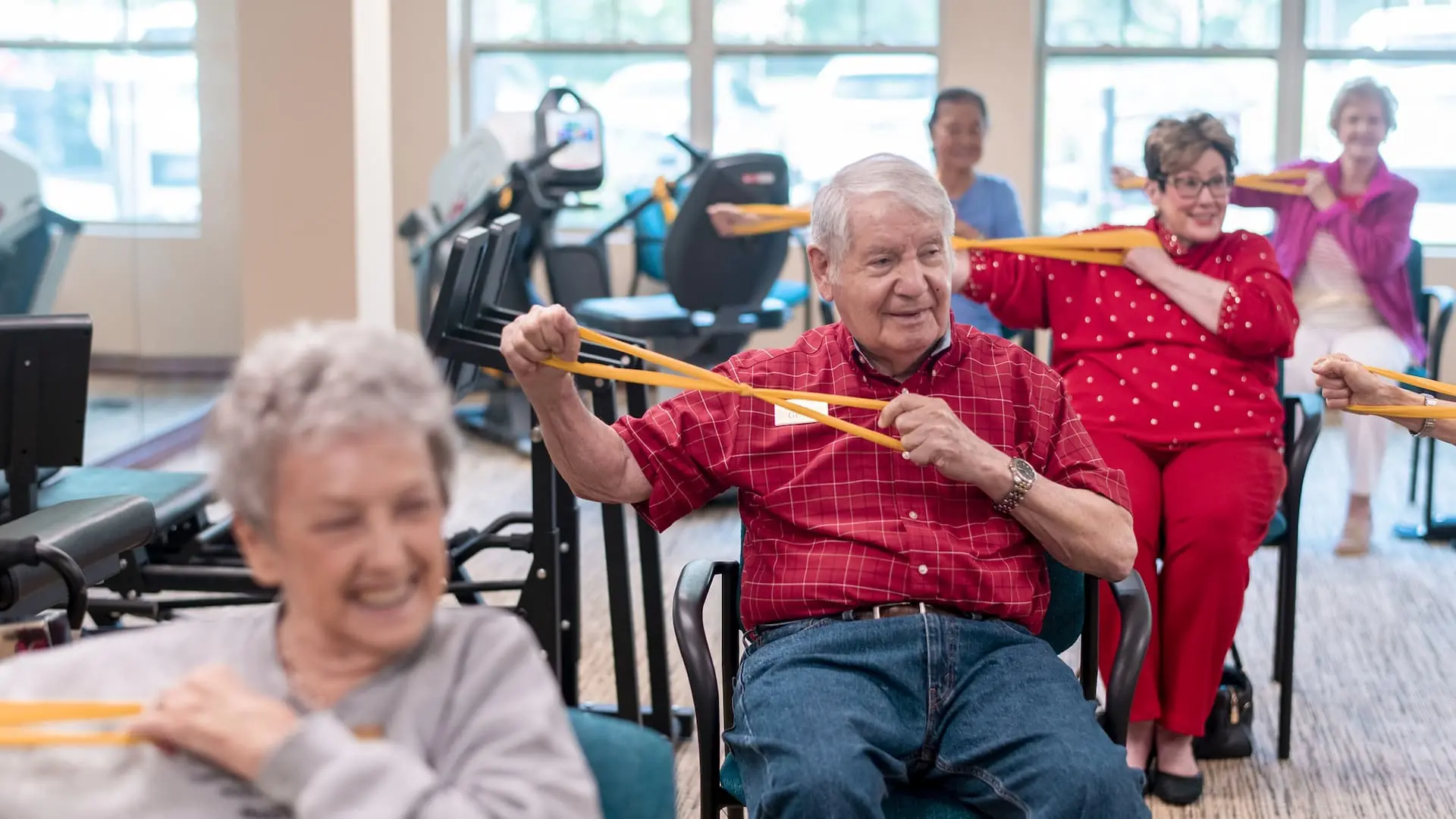 Residents participating in a group exercise class in a common area