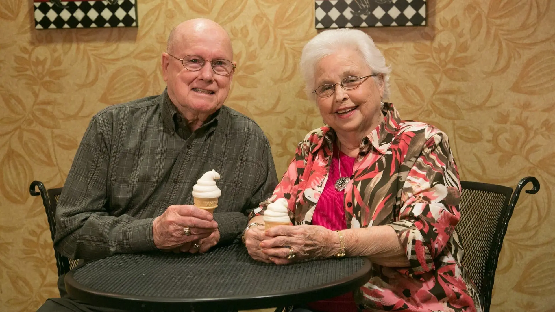 Elderly couple enjoying ice cream in a common area