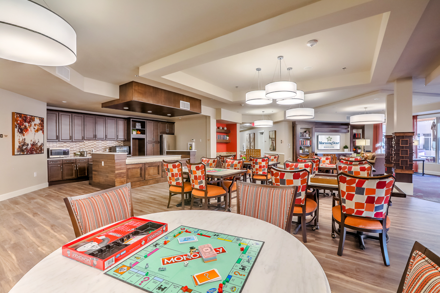 Interior common area with residents playing a board game