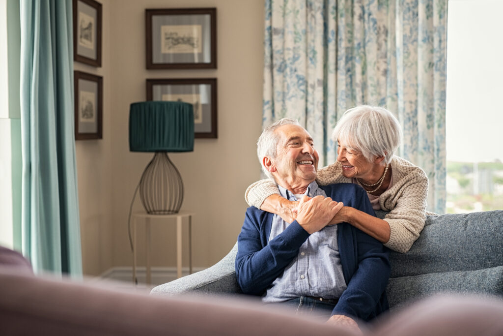 Elderly couple enjoying time together in a cozy living room