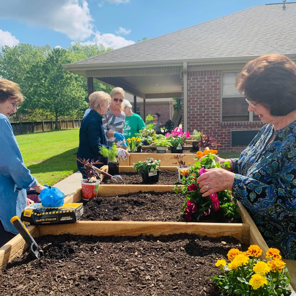 Residents gardening in outdoor planter boxes