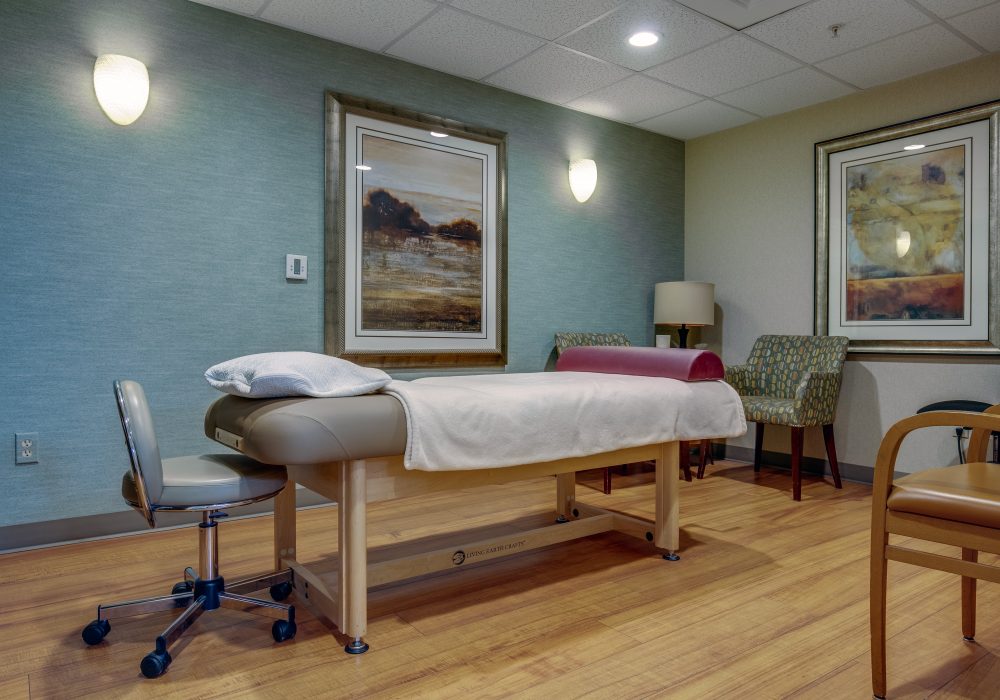Therapy room with treatment table and chairs