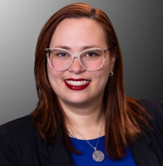 A woman smiling in professional attire