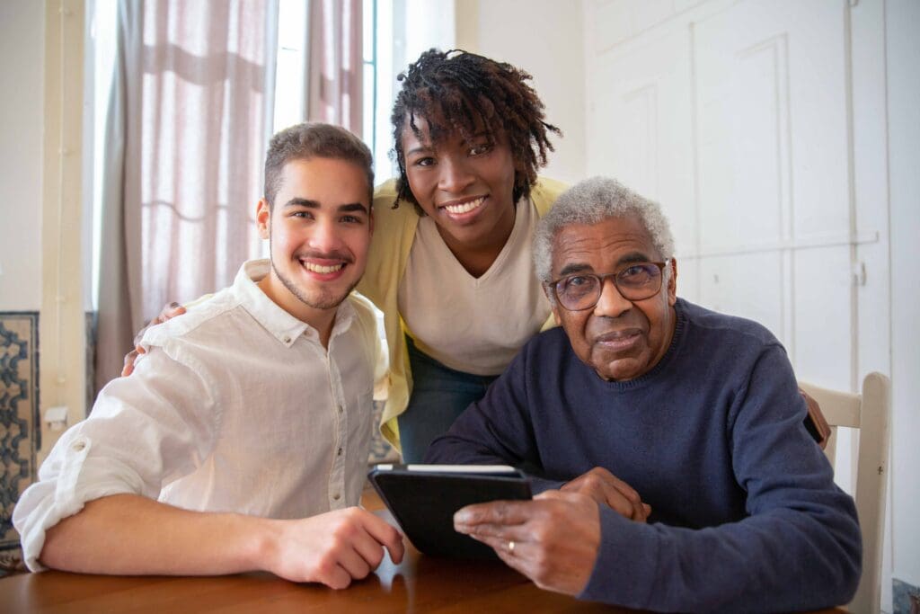 Three individuals enjoying time together with a tablet