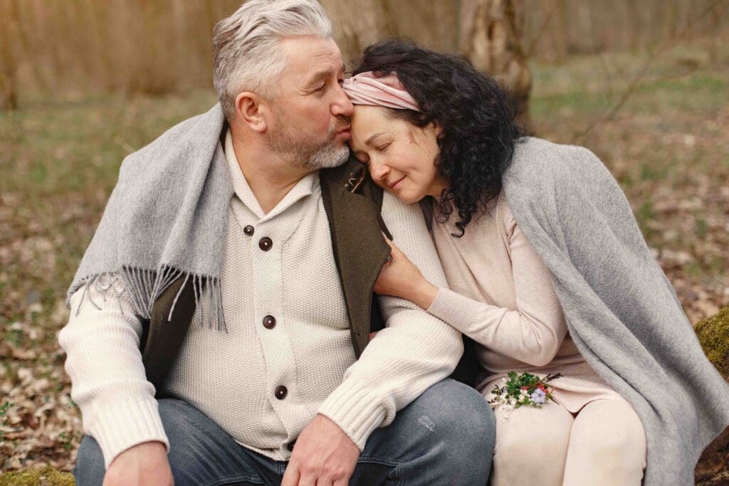 A couple sitting together in a peaceful outdoor setting
