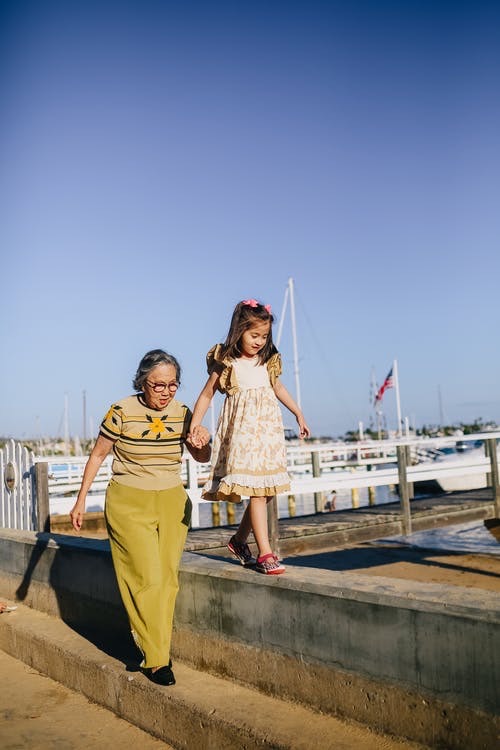 Senior and child walking by the waterfront