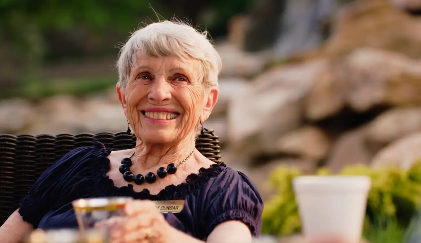 A smiling elderly woman enjoying time outdoors