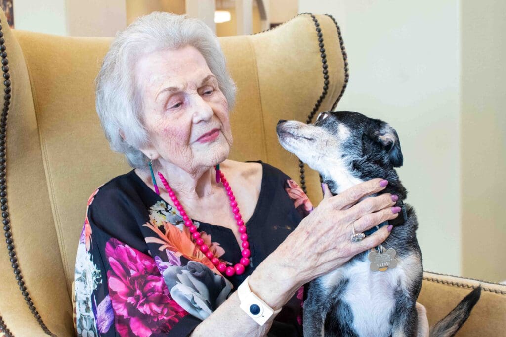 Senior resident with a dog in a cozy chair