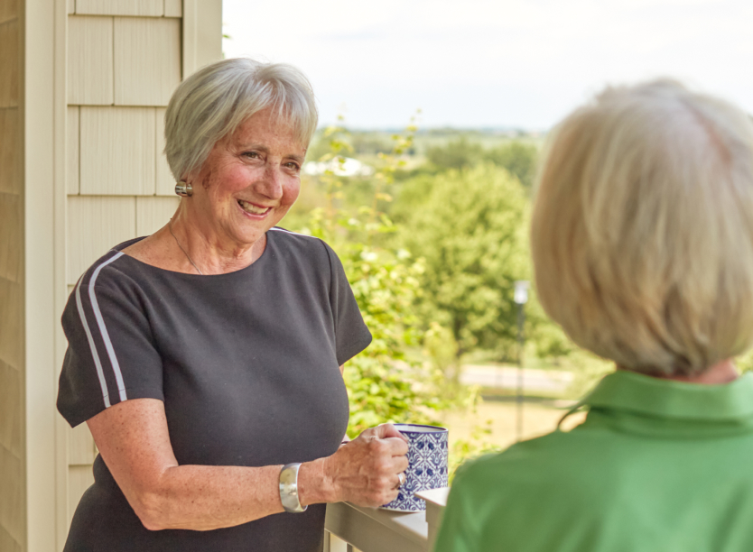 Two women enjoying a conversation on a balcony