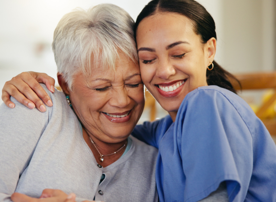 Caregiver and resident sharing a joyful moment