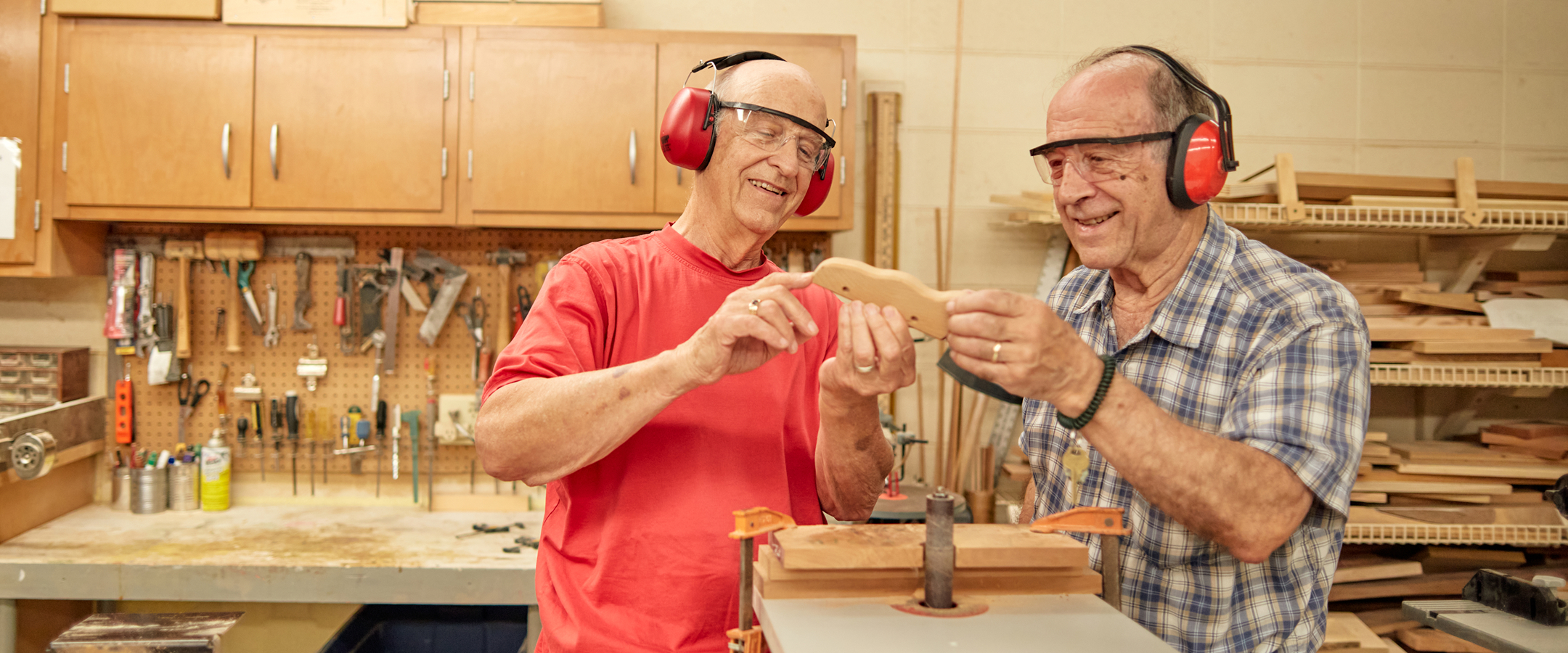 Two residents engaging in woodworking activities