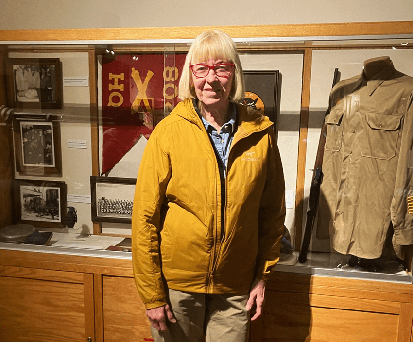A woman in a museum with historical memorabilia