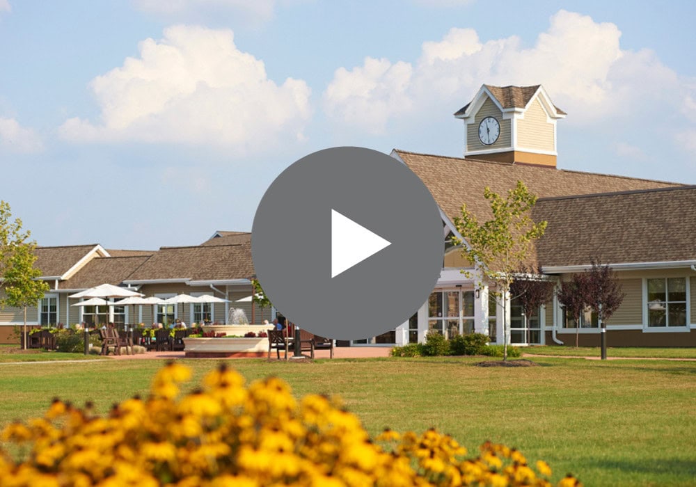 Exterior view of assisted living facility with gardens