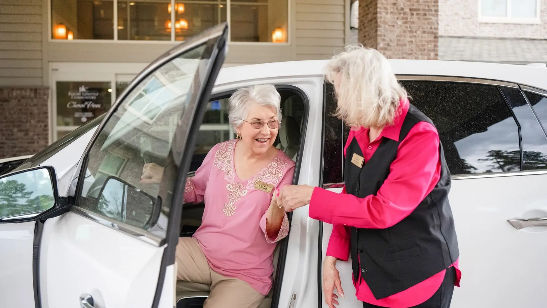Residents being assisted from a vehicle outside