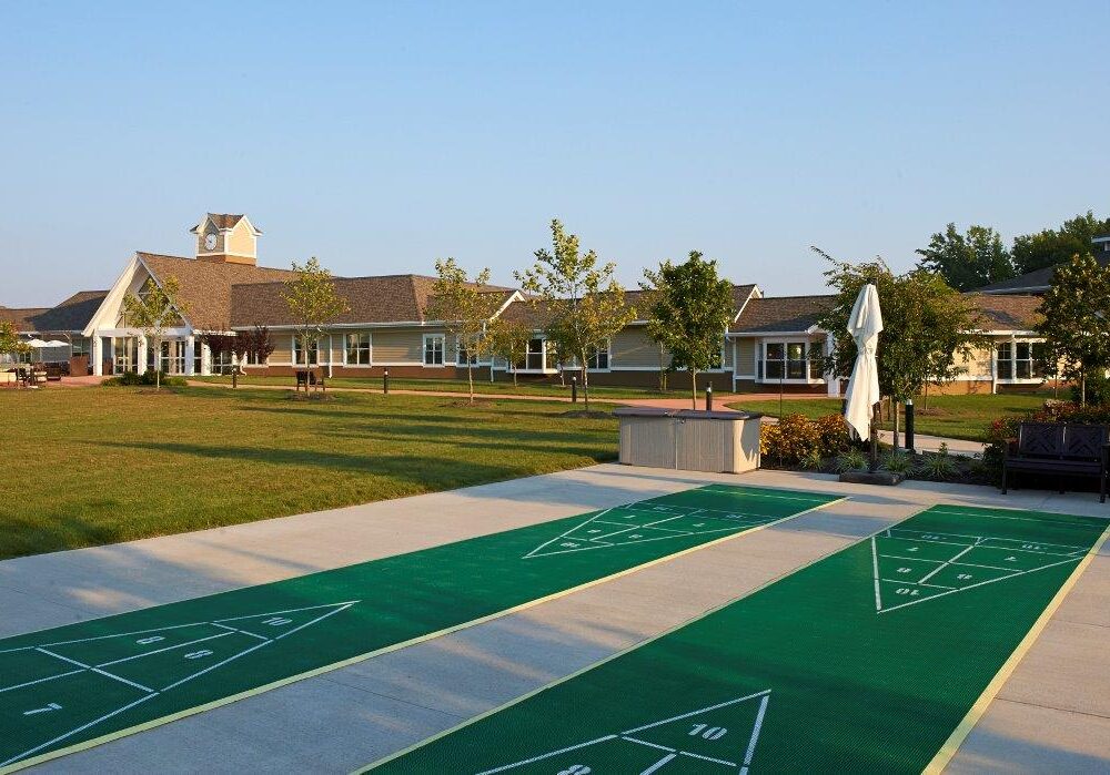 View of outdoor space with shuffleboard and facility building