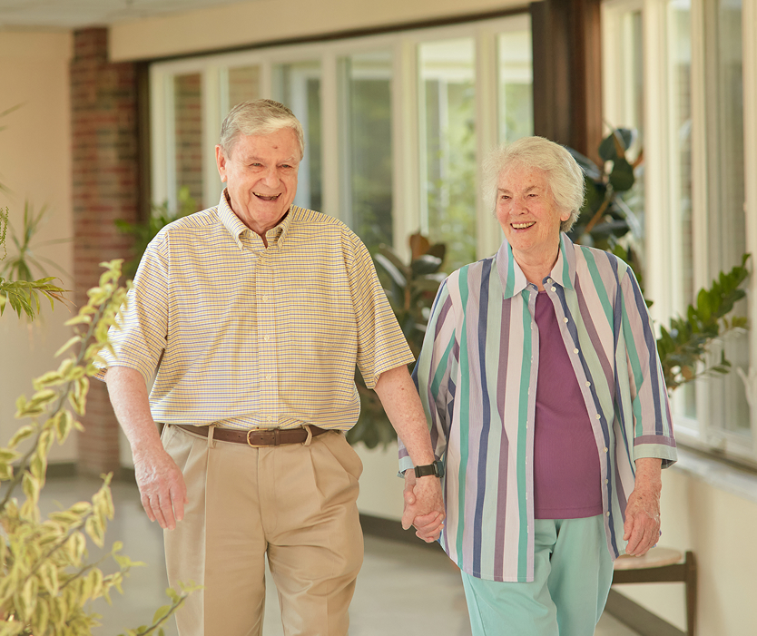 Residents walking together in a bright hallway
