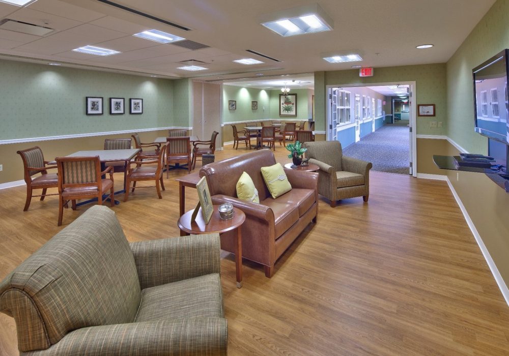 Common area with seating and tables in a senior living facility