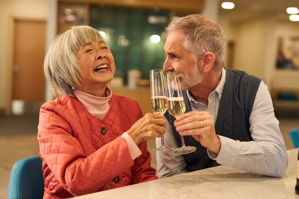 Happy residents toasting with champagne glasses