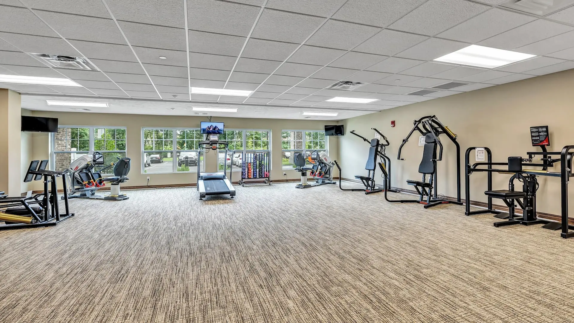 Fitness center with exercise equipment and large windows