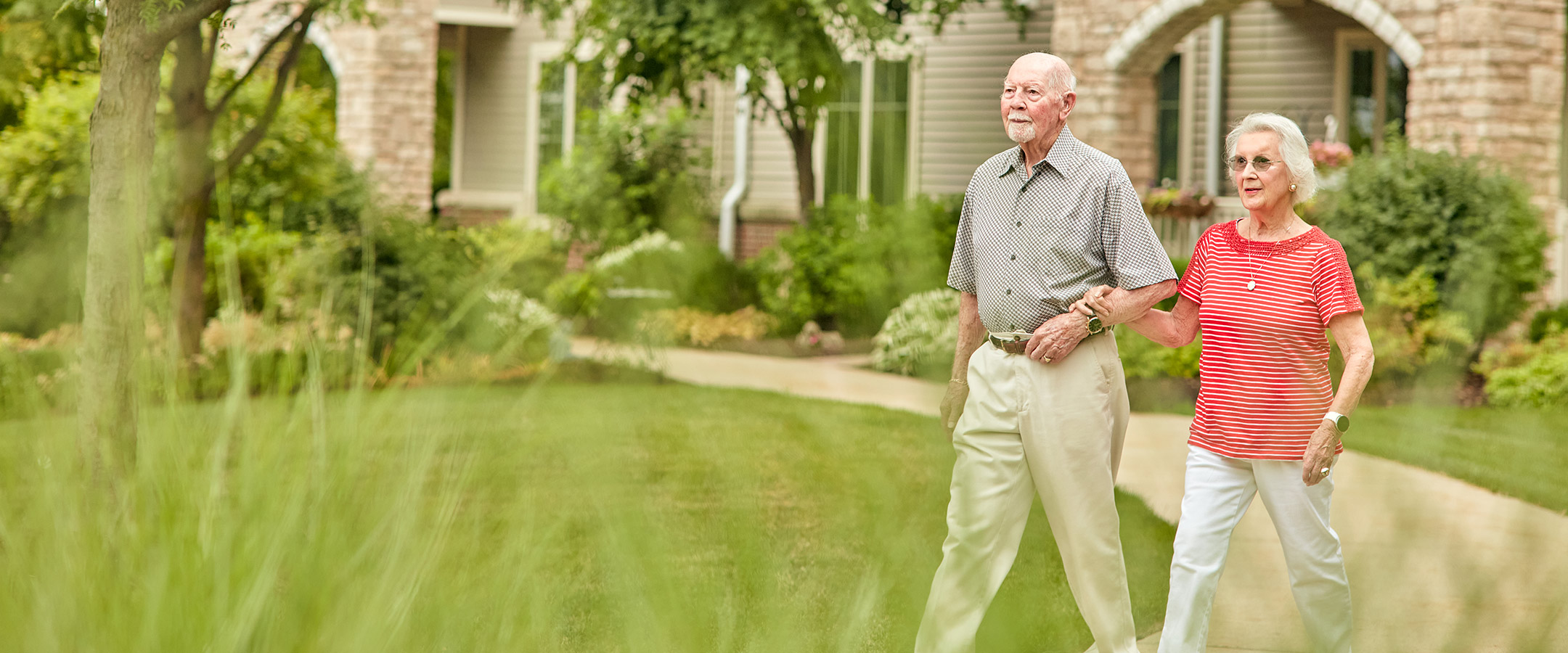 A couple walking together in a garden pathway