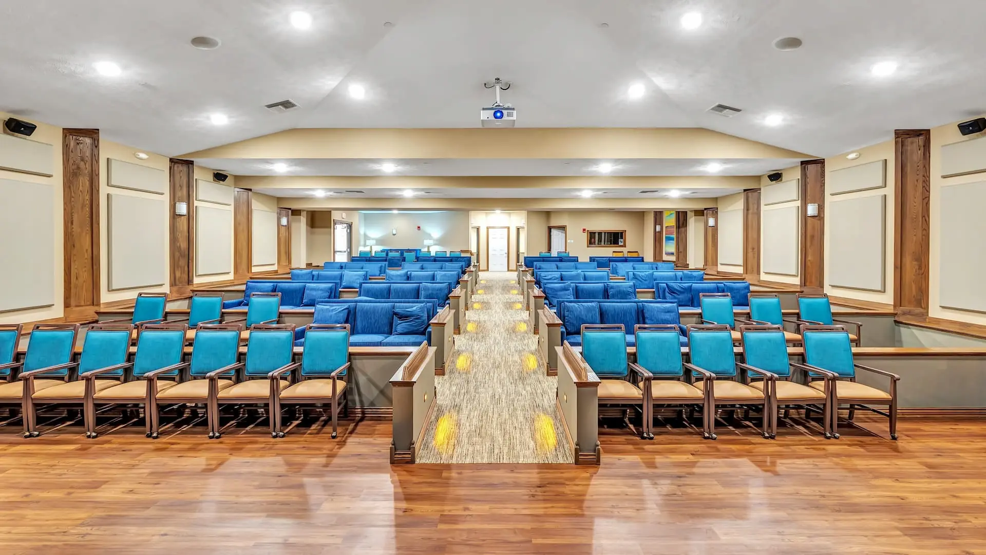 Interior view of a spacious activity room with blue seating