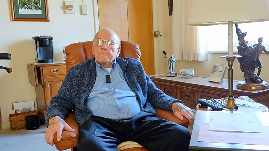 An elderly man seated in a cozy room