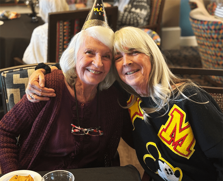 Two residents celebrating and smiling together
