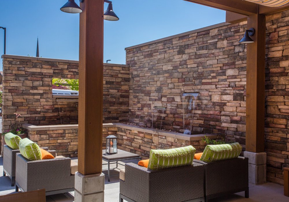 Outdoor seating area with fountain and greenery