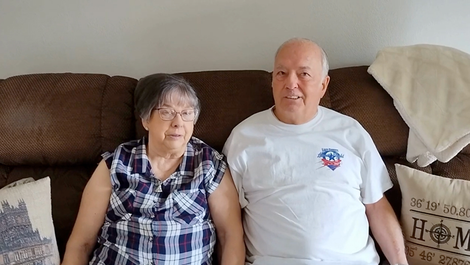 Two residents sitting together on a couch