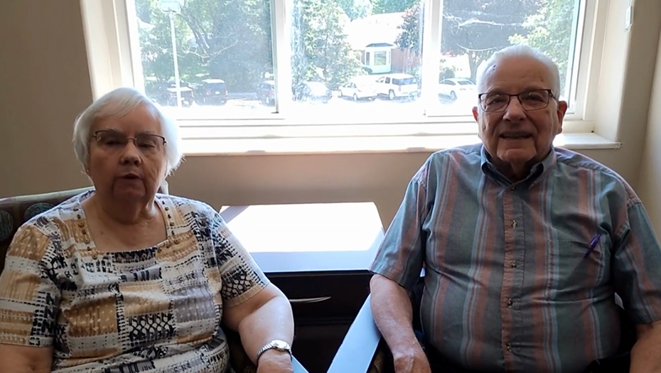 Two residents sitting together in a common area