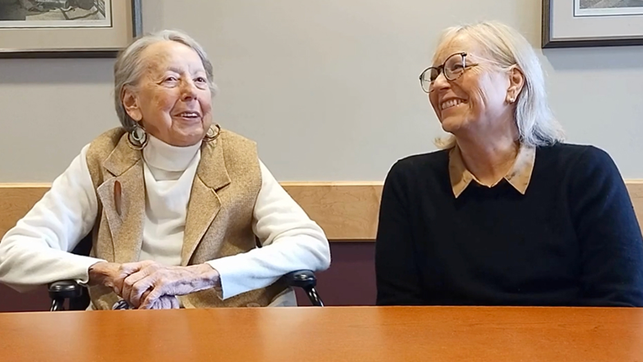 Two women smiling in an indoor setting